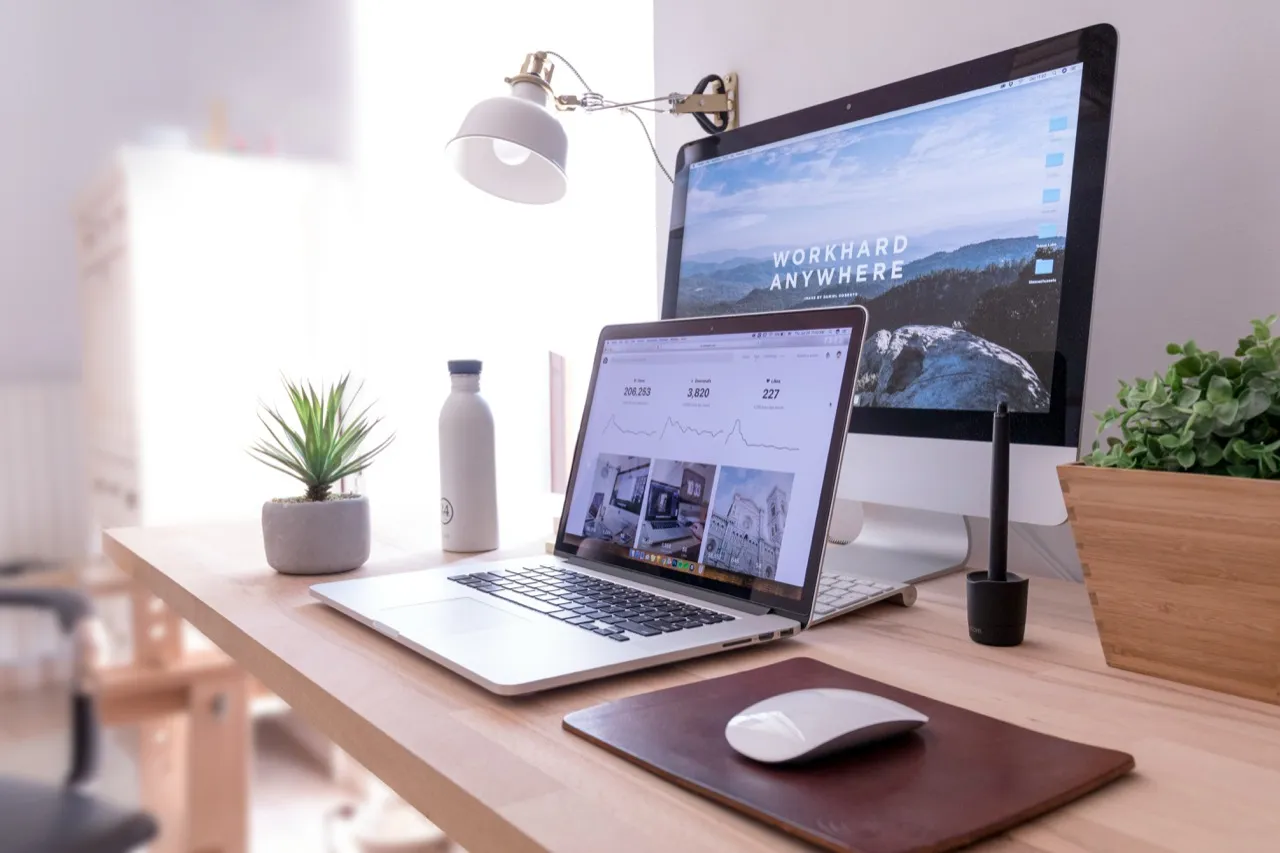 Laptop and iMac on a bright minimalist desk